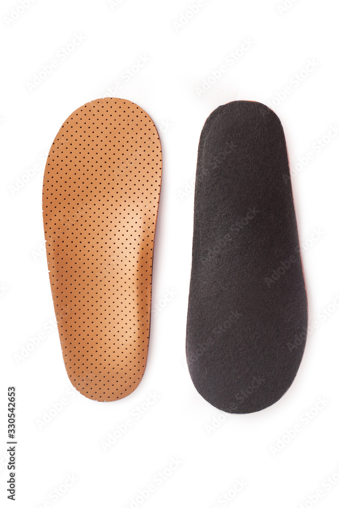 Isolated orthopedic insole on a white background. Treatment and prevention of flat feet and foot diseases. Foot care, comfort for the feet. Wear comfortable shoes. Medical insoles. Isolated orthopedic insole on a white background. Treatment and prevention of flat feet and foot diseases. Foot care, comfort for the feet. Wear comfortable shoes. Medical insoles.