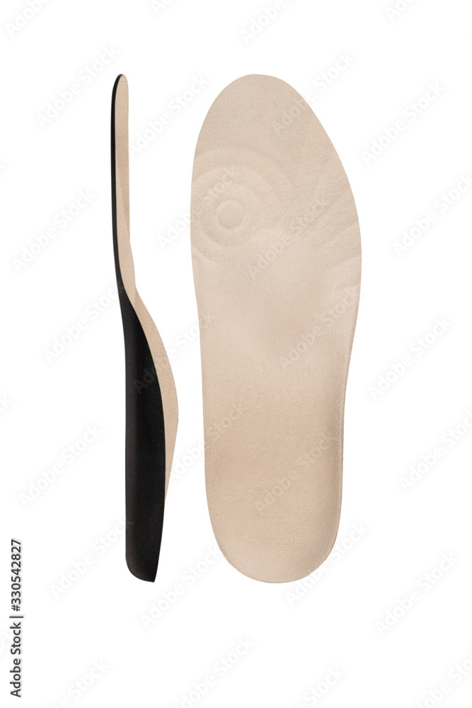 Isolated orthopedic insole on a white background. Treatment and prevention of flat feet and foot diseases. Foot care, comfort for the feet. Wear comfortable shoes. Medical insoles. Isolated orthopedic insole on a white background. Treatment and prevention of flat feet and foot diseases. Foot care, comfort for the feet. Wear comfortable shoes. Medical insoles.