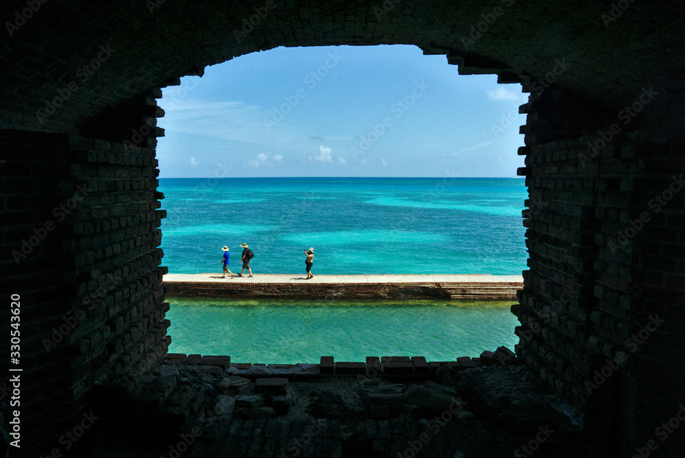 Tourists walking on the moat wall in Dry Tortugas National Park