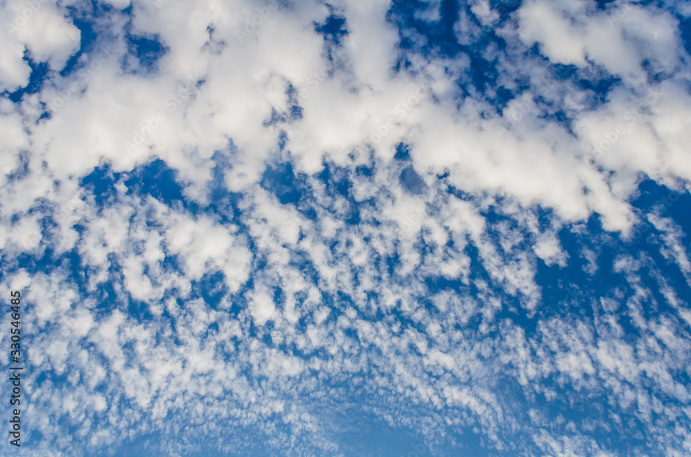 White clouds in a bright blue sky. The beauty of the nature