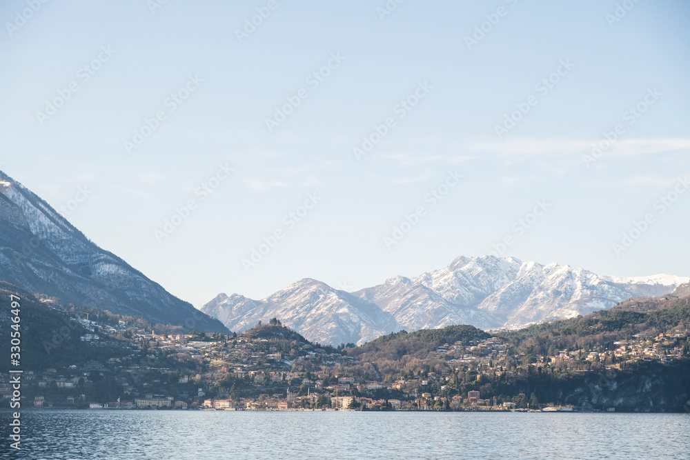 Snowy peaks of Alps mountains on a clear sunny day, panorama of Lago di Como	