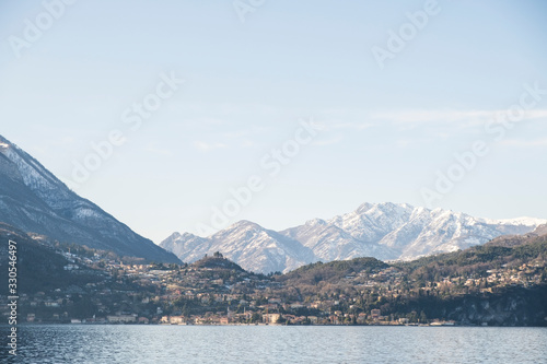 Snowy peaks of Alps mountains on a clear sunny day, panorama of Lago di Como 