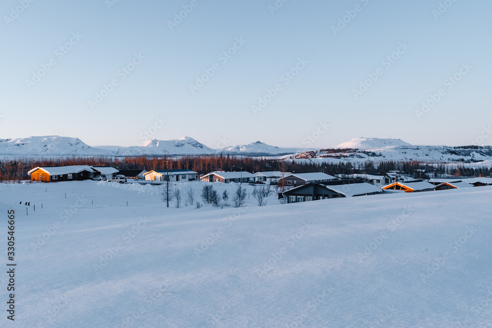 A winter wonderland in Iceland. Photograph shows one of the frozen Icelandic villages during the golden hour. Tourism in Iceland. Visit Iceland any time of the year A winter wonderland in Iceland. Photograph shows one of the frozen Icelandic villages during the golden hour. Tourism in Iceland. Visit Iceland any time of the year