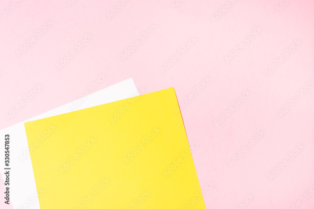 White and yellow blank paper on pink background. Empty free space. background. White and yellow blank paper on pink background. Empty free space. background.