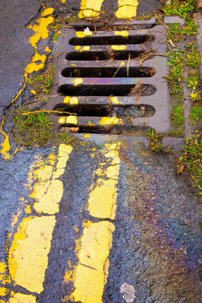 Petrol Gasoline Oil Spill on The Road Tarmac Rainbow Colour Pollution