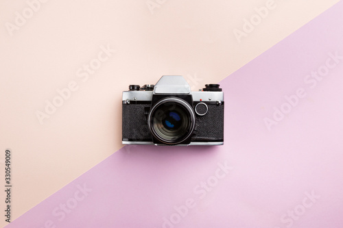 Vintage camera on color background. Retro style toned picture. Minimalistic concept
