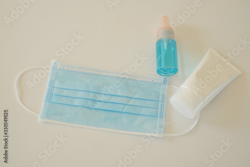 Coronavirus prevention item  medical surgical masks  spray alcohol and hand sanitizer gel for cleaning  hygiene and protect ill  fluid germ  virus infection and bacteria. Personal hygiene concept.