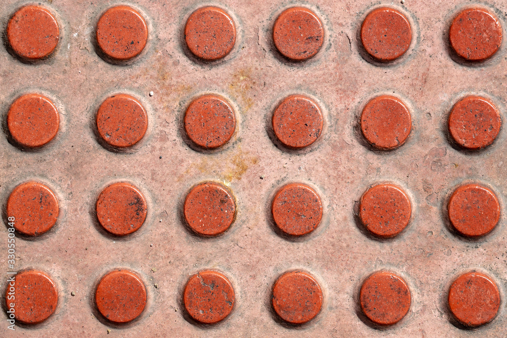 Tactile paving texture. Truncated domes top view. Detectable warnings. Close-up of walking surface indicators. Tactile paving texture. Truncated domes top view. Detectable warnings. Close-up of walking surface indicators.