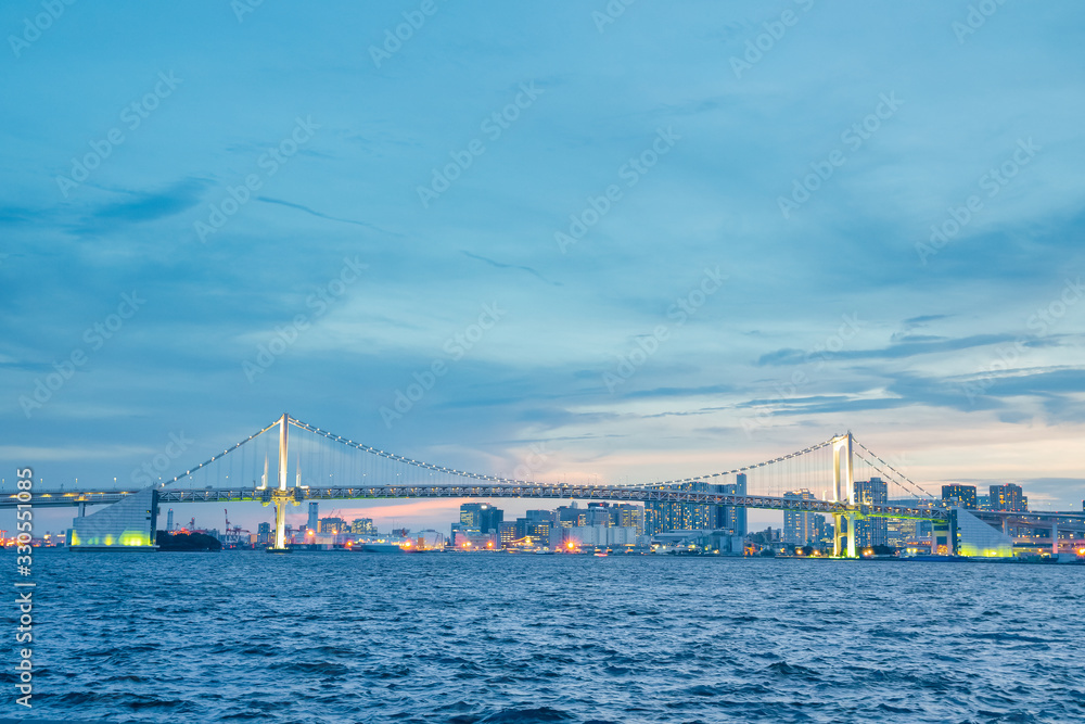 Naklejka premium Rainbow bridge eveing in Tokyo city.