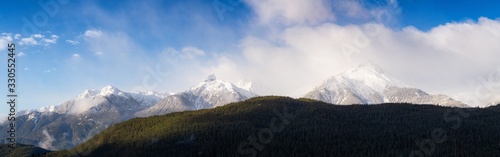 Panoramic Canadian Landscape View of the Rocky Mountain Peaks during a cloudy morning. Taken in Tantalus Lookout near Squamish and Whistler  North of Vancouver  BC  Canada. Background Panorama