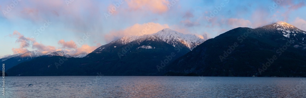 Porteau Cove, Howe Sound, near Squamish and Vancouver, British Columbia, Canada. Beautiful Panoramic Mountain Landscape View of a colorful morning sunrise in winter. Nature Background Panorama