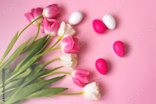 Fototapeta Naklejka Na Ścianę i Meble -  Happy Easter! Bright plastic Easter eggs on a pink background. Decorating the kitchen for Easter on a Sunny day. Greeting card.