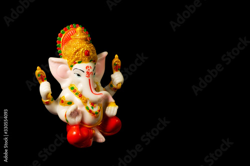The statue of Lord Ganesha with the correct composition on the black background