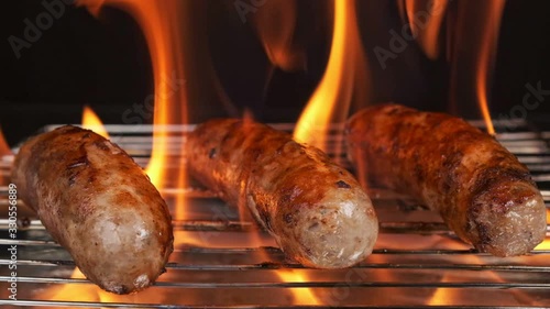 Close up. Delicious sausages are grilled on the fire. Grilled sausages are fried on fire.