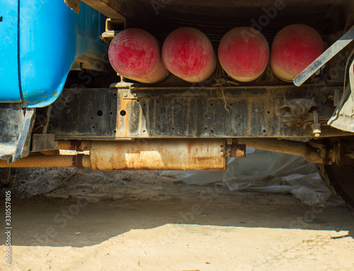 truck with red gas cylinders on the sand
