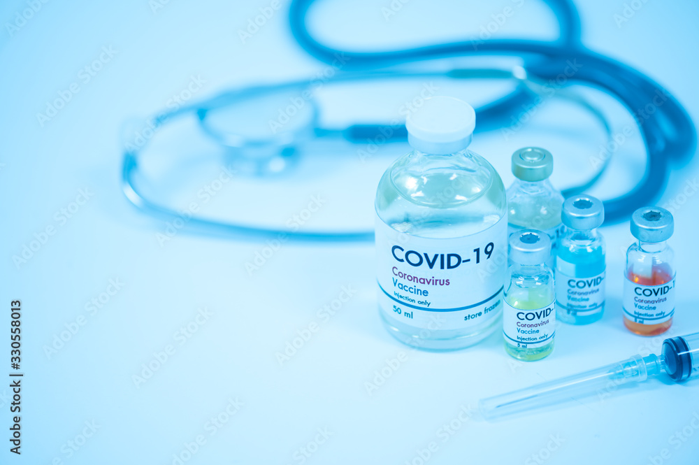 Vaccine bottles, syringe and stethoscope on white background.Vaccination against coronavirus quarantine or covid-19.Protection against virus and infection control.Medication treatment concept. Vaccine bottles, syringe and stethoscope on white background.Vaccination against coronavirus quarantine or covid-19.Protection against virus and infection control.Medication treatment concept.