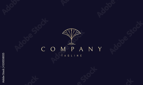 Vector golden logo on which an abstract image of a tree.
