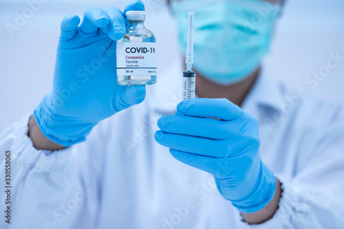 Doctor's hand holding syringe and bottle for vaccine to patient .Vaccination against coronavirus quarantine or covid-19.Protection against virus and infection control.Medication treatment concept.