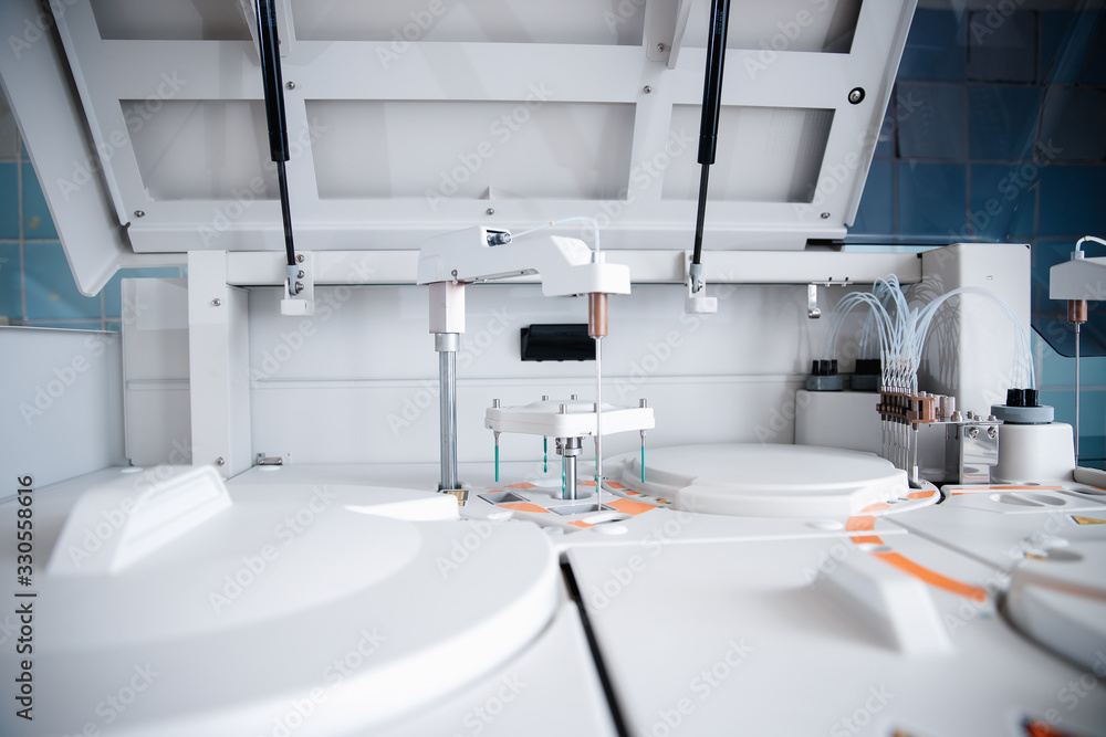 Automatic robot microbiologist analyzing test tube of blood samples for viruses. Concept vaccine search coronavirus 2019-nCoV