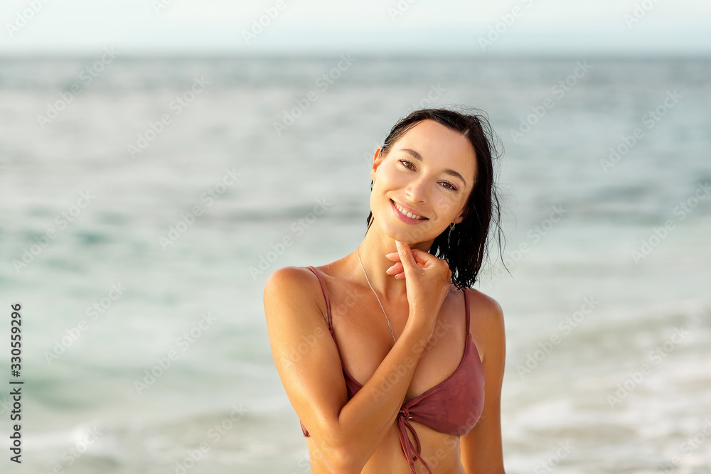 Beautiful woman by the ocean at sunset Beautiful woman by the ocean at sunset