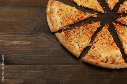 cheese pizza on dark wooden background