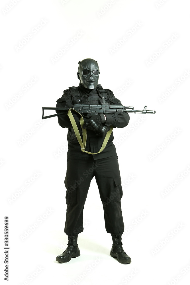 man in a black military uniform holding machine gun and standing full ...