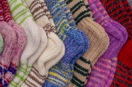 There are multi-colored knitted warm wool socks. warm winter clothing handmade.