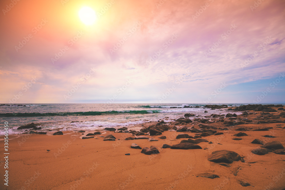 Seascape in the evening. Sunset on the beach. Sandy rocky seashore with cloudy sky Seascape in the evening. Sunset on the beach. Sandy rocky seashore with cloudy sky