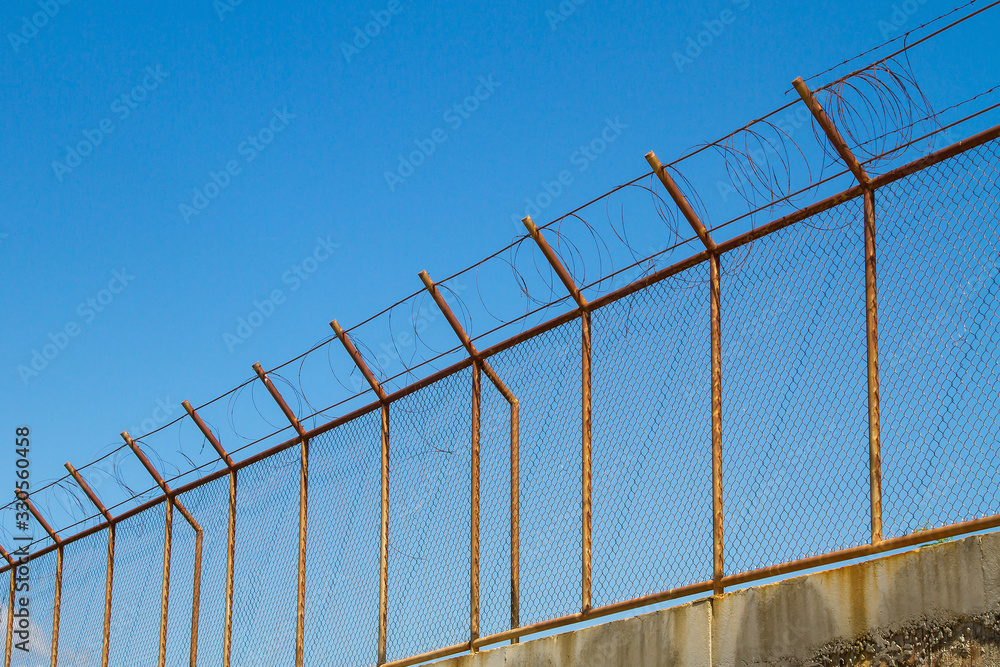 Restricted area fence against blue sky Restricted area fence against blue sky