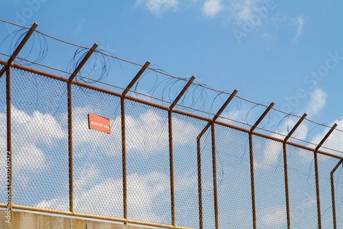 Restricted area fence against blue sky