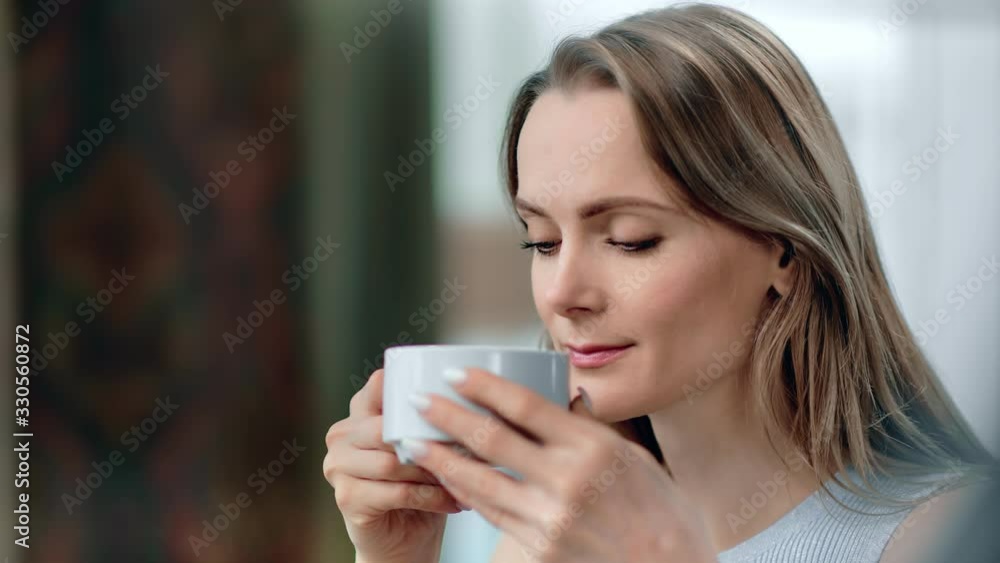 Close up pleasant face of attractive blonde female drink hot beverage. 4k Dragon RED camera Close up pleasant face of attractive blonde female drink hot beverage. 4k Dragon RED camera
