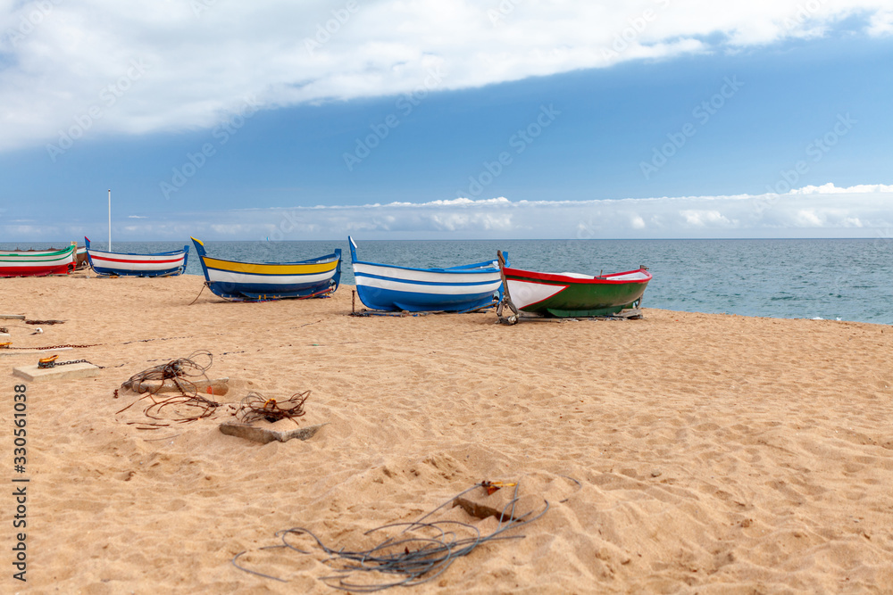 fishing boats on the coastline of the sea