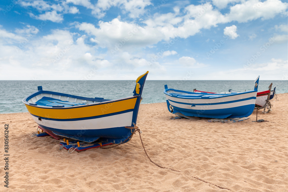 several colorful fishing boats by the sea on a sunny day