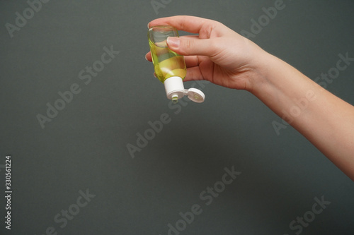 Female hands squeezing antibacterial gel. Antiseptic hand gel for hands disinfection and cleaning during flu virus outbreak, coronavirus epidemic and infectious diseases 