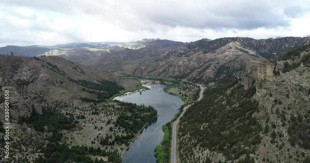 Aerial drone scene flying above pure blue river at mountainous landscape. Rocky cliffs and pine woods at mountain slopes. Alumine river. Beautiful valley of Valle Encantado, Bariloche, Rio negro. Aerial drone scene flying above pure blue river at mountainous landscape. Rocky cliffs and pine woods at mountain slopes. Alumine river. Beautiful valley of Valle Encantado, Bariloche, Rio negro.