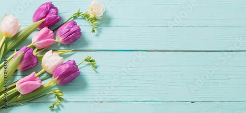 spring flowers on blue mint wooden background