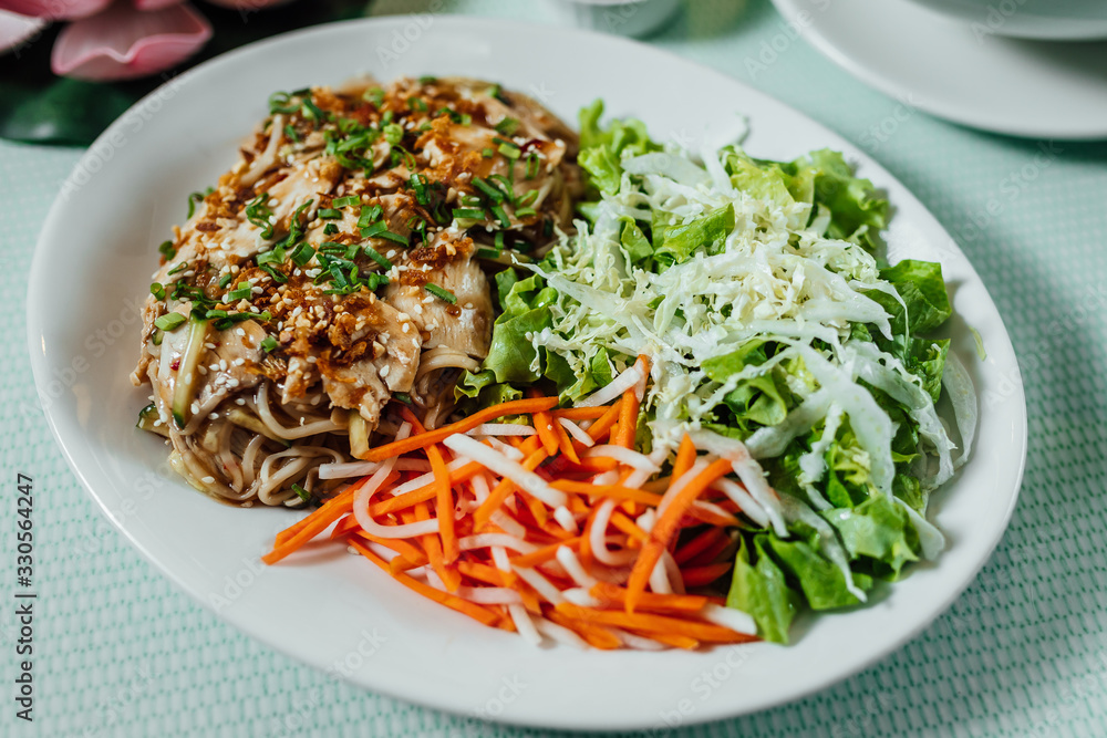 Delicious cooked chicken served with green salads and carrots. Gourmet food Delicious cooked chicken served with green salads and carrots. Gourmet food