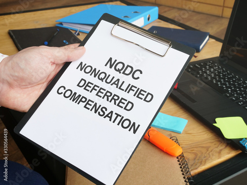 Writing note shows the text nonqualified deferred compensation NQDC