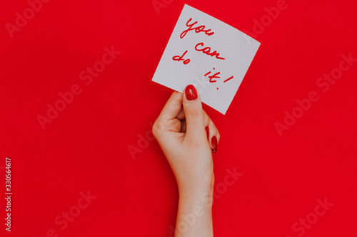 Note in a female hand with manicure, red nails. 