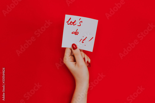Note in a female hand with manicure, red nails. 