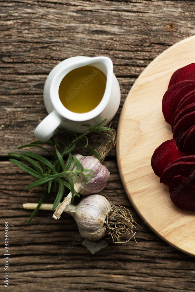 Beetroot Chips. The process of making snacks. Handmade healthy vegetable chips. On a cutting board are slices of root vegetables. Garlic and oregano spices for the dish. Soft focus Beetroot Chips. The process of making snacks. Handmade healthy vegetable chips. On a cutting board are slices of root vegetables. Garlic and oregano spices for the dish. Soft focus