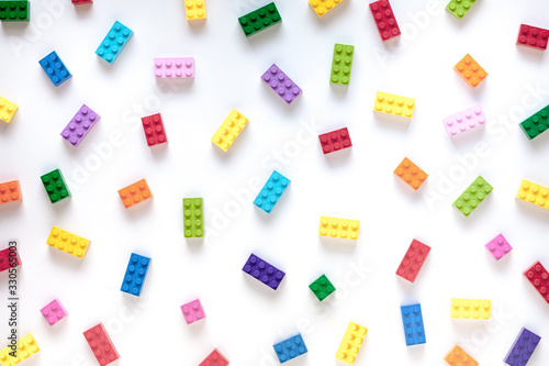 Colored toy bricks on white background