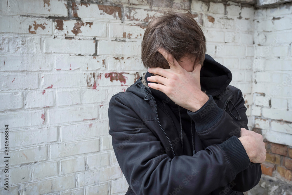 Addict male depressed while covering his face. Addiction concept. Addict male depressed while covering his face. Addiction concept.