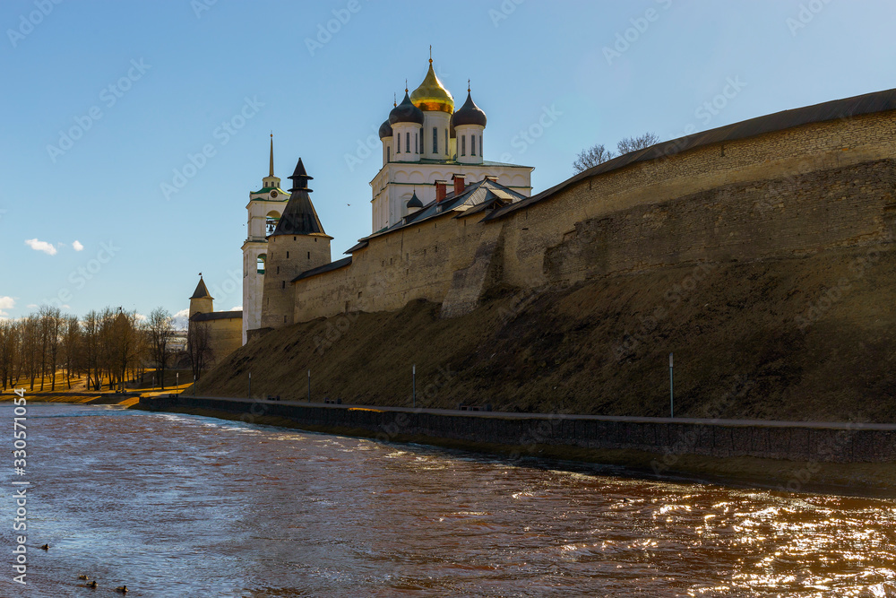 Spring panorama of an old medieval fortress standing on the river Bank. Pskov, Russia.