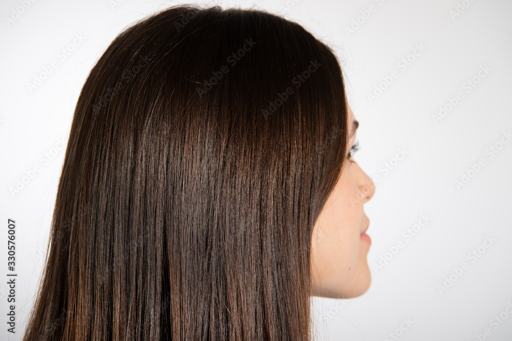 Rear view of gorgeous brunette woman. Focused on beautiful long brown glossy hair. Isolated on white background. Hair care concept... Rear view of gorgeous brunette woman. Focused on beautiful long brown glossy hair. Isolated on white background. Hair care concept...