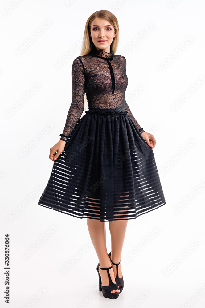 Attractive girl in a dress against a white wall Attractive girl in a dress against a white wall