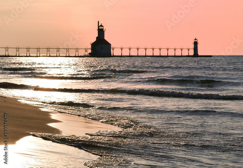 Sunset photo of the St Joseph Michigan North Pier Lighthouse and Lake Michigan taken from Tiscornia Park