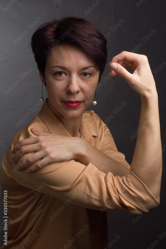 brunette with short hair. Studio portrait in a yellow blouse brunette with short hair. Studio portrait in a yellow blouse