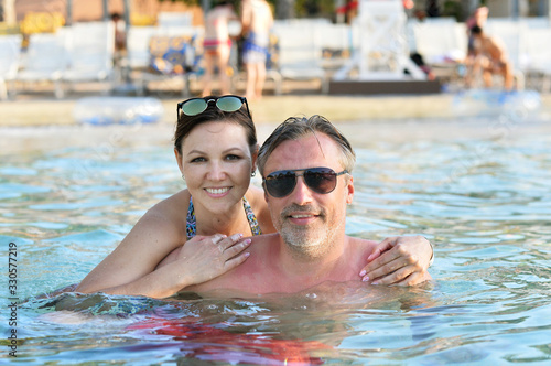 Portrait of cute family relaxing in the pool © aletia2011