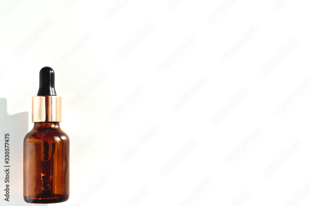 Fototapeta premium brown bottle with pipette on a white background. the view from the top